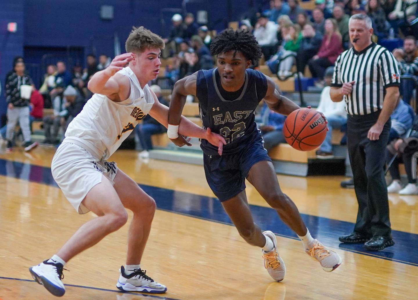 Oswego East's Jehvion Starwood (22) drives to the hoop against Neuqua Valley's Luke Kinkade (32) during a hoops for healing basketball tournament game at Oswego High School on Friday, Nov 24, 2023.