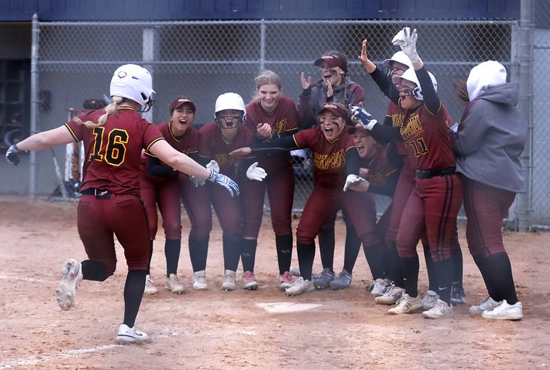 Richmond-Burton’s Taylor Davison is greeted by her teammates after hitting a game winning home run during a non-conference softball game against Cary-Grove Tuesday, March 21, 2023, at Cary-Grove High School.