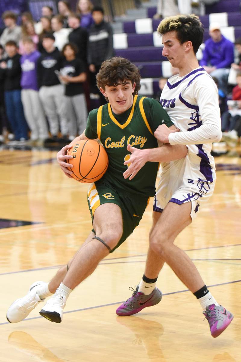 Coal City's Gavin Berger, left, drives to the basket as Manteno's Braden Campbell defends during the IHSA Class 2A Manteno Regional quarterfinals Monday, Feb. 23, 2026.
