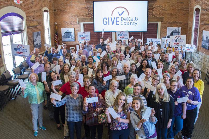 Representatives from participating nonprofits gather after the check presentation for Give DeKalb County 2019. A total of $751,050 was raised in this 24-hour giving day last year.