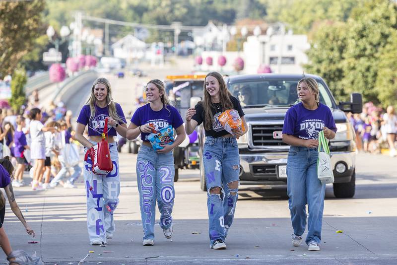 Members of the Dixon volleyball squad throw candy Friday, Oct. 3, 2025, during the homecoming parade.