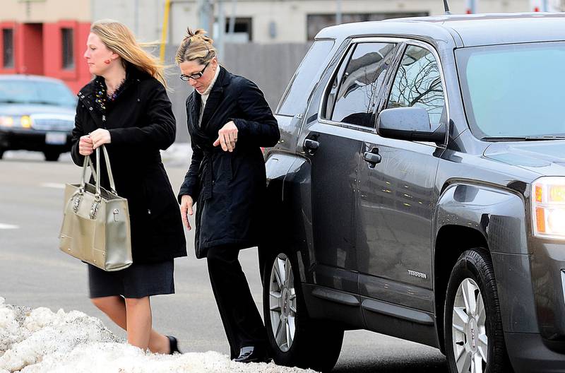 Rita Crundwell (right) exits a vehicle in front of the federal courthouse in Rockford February 14, 2012. Crundwell will be sentenced later this morning.