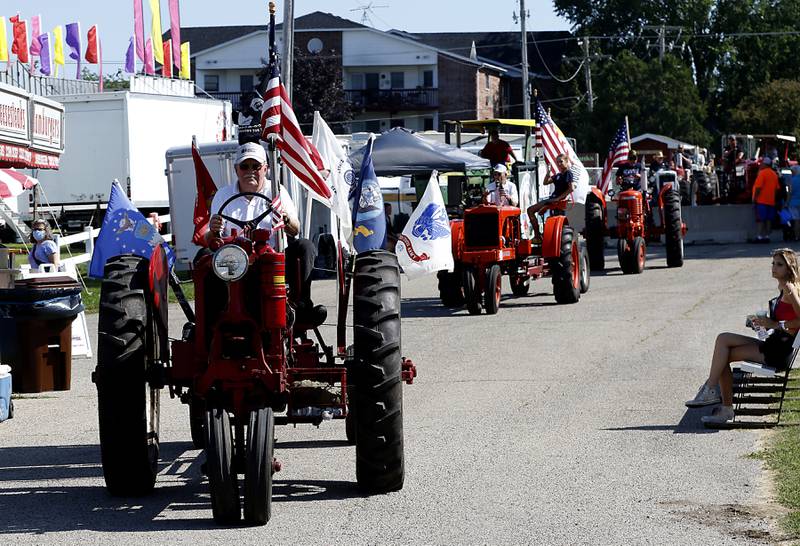 Harry Alten leads the antique tractor parade in his 1939 Farmall Model F-14 tractor during the first day of the McHenry County Fair Tuesday, August 2, 2022, at the fairgrounds in Woodstock.