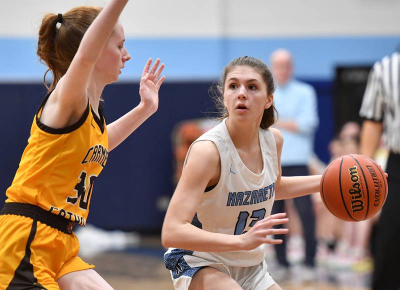 Nazareth's June Foley (right) looks to pass as Carmel's Keira Ackerson defends during the ESCC conference tournament championship game on Feb. 4, 2023 at Nazareth Academy in LaGrange Park.