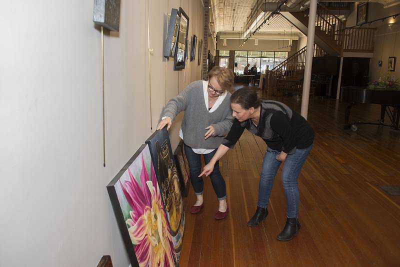 Gloria Nusbaum (left) and Jayne Rose talk about a painting that was submitted to the Phidian Art Show. The show will accept submissions until Monday, March 28, 2022 between the hours of 2-6 p.m. at The Next Picture Show in Dixon.