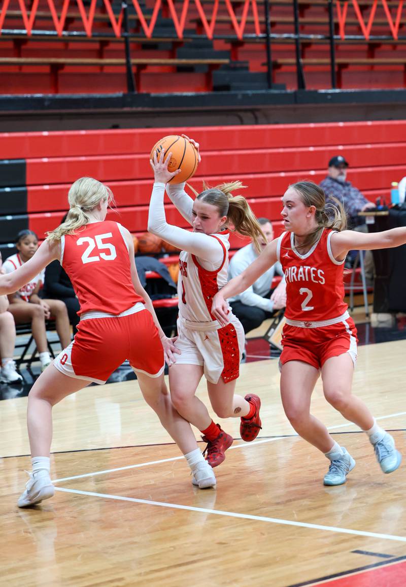 Bradley-Bourbonnais' Naturel Coday looks to evade Ottawa's Libby Muffler (25) and Ashlynn Ganiere (2) during Ottawa's 55-44 victory on Monday, Feb. 9, 2026.