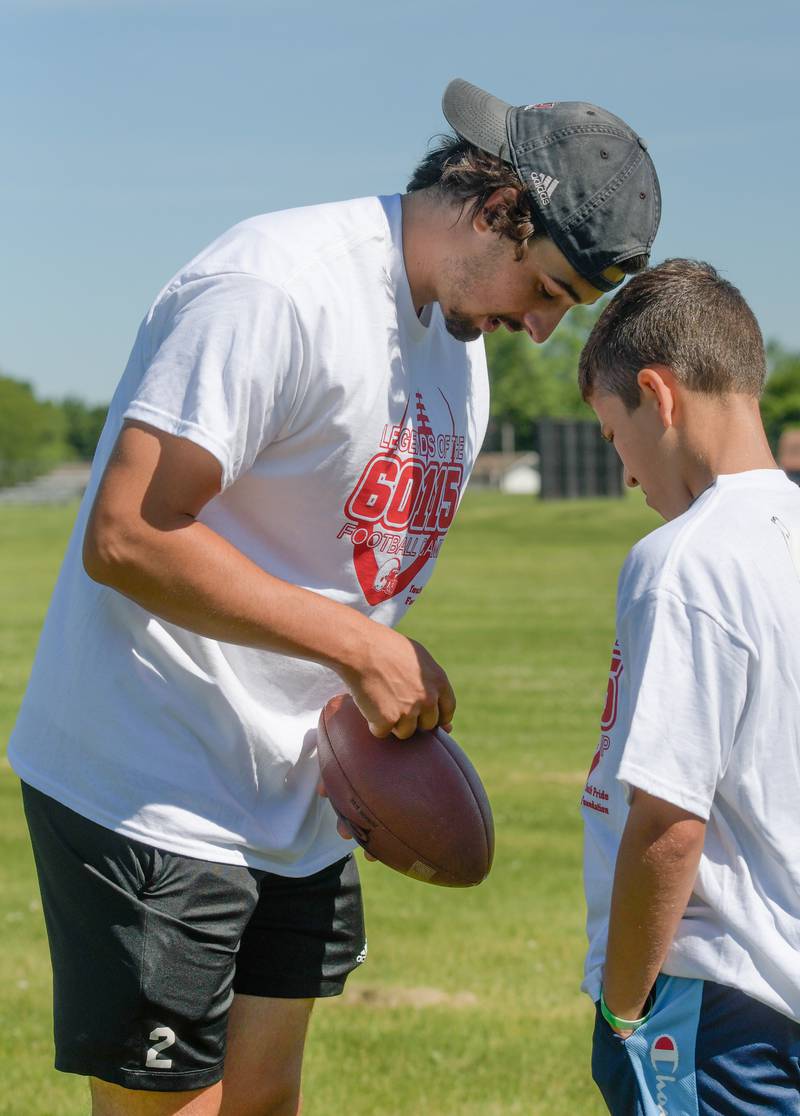 NIU Quarterback Ethan Hampton sets up the pass play with Gavin Stevenson, 13 during the inaugural Legends of the 60115 Football Camp in DeKalb on Sunday, June 26, 2022.