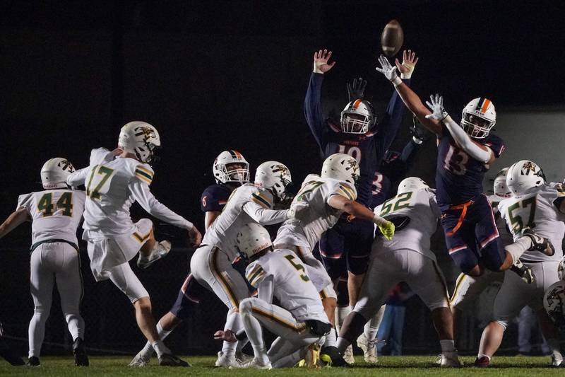 Oswego’s Trent Wollwert-Angle (left) and Jordan Sweiss (13) defend against a field goal attempt by Waubonsie Valley's Cade Valek (17) during a Class 8A first-round playoff game at Oswego High School on Friday, Nov. 1, 2024.