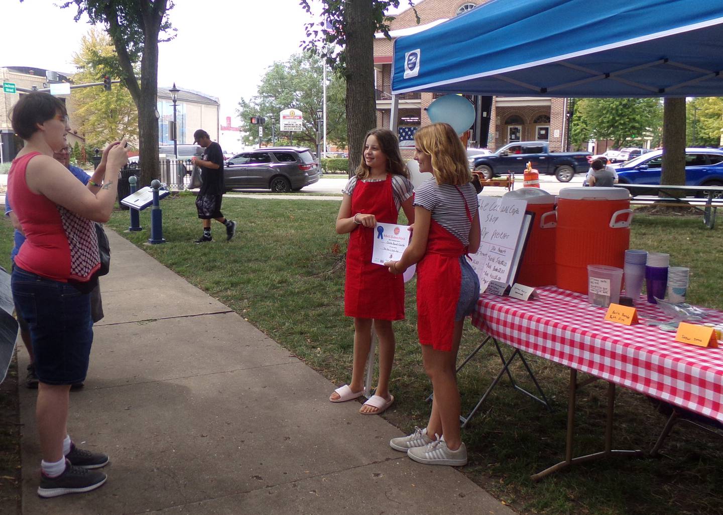 Cayla Blood, 11, of Ottawa, and Ceci Reynolds, 12, of Utica, pose for a photo Saturday, Aug. 13, 2022, in front of Ceci and Cayla's Shop, after receiving an award during the Ottawa Children's Business Fair at Washington Square.