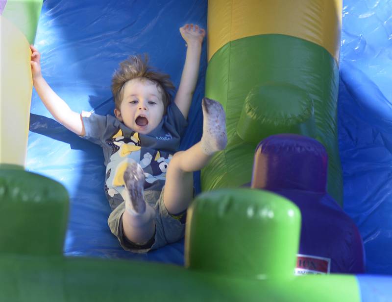Dartagnan Kreinbrink feels the excitement as he slides down in a bounce house slide Saturday during the annual Scarecrow Festival in Ottawa.