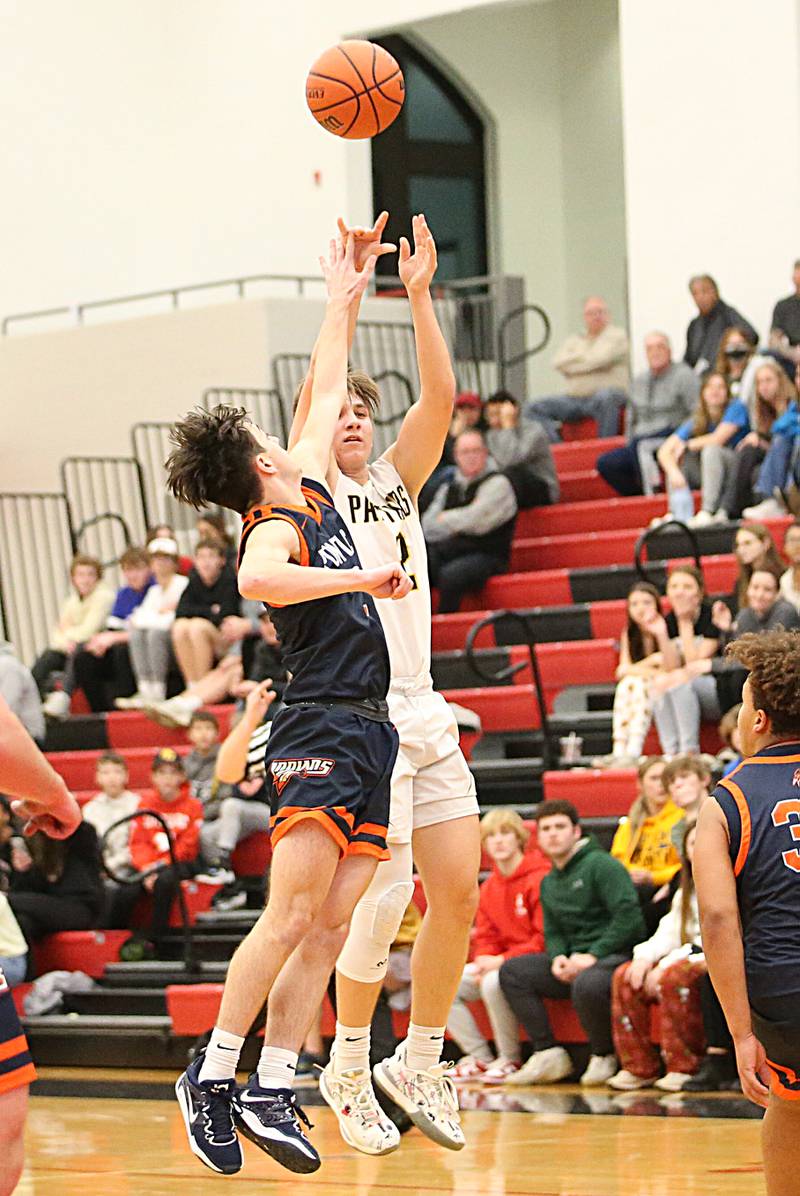 Putnam County's Andrew Pyszka (right) misses this three.point buzzer beater at halftime as Pontiac's Camden Fenton (left) defends during the Colmone Classic tournament on Friday, Dec. 9, 2022 at Hall High School in Spring Valley.