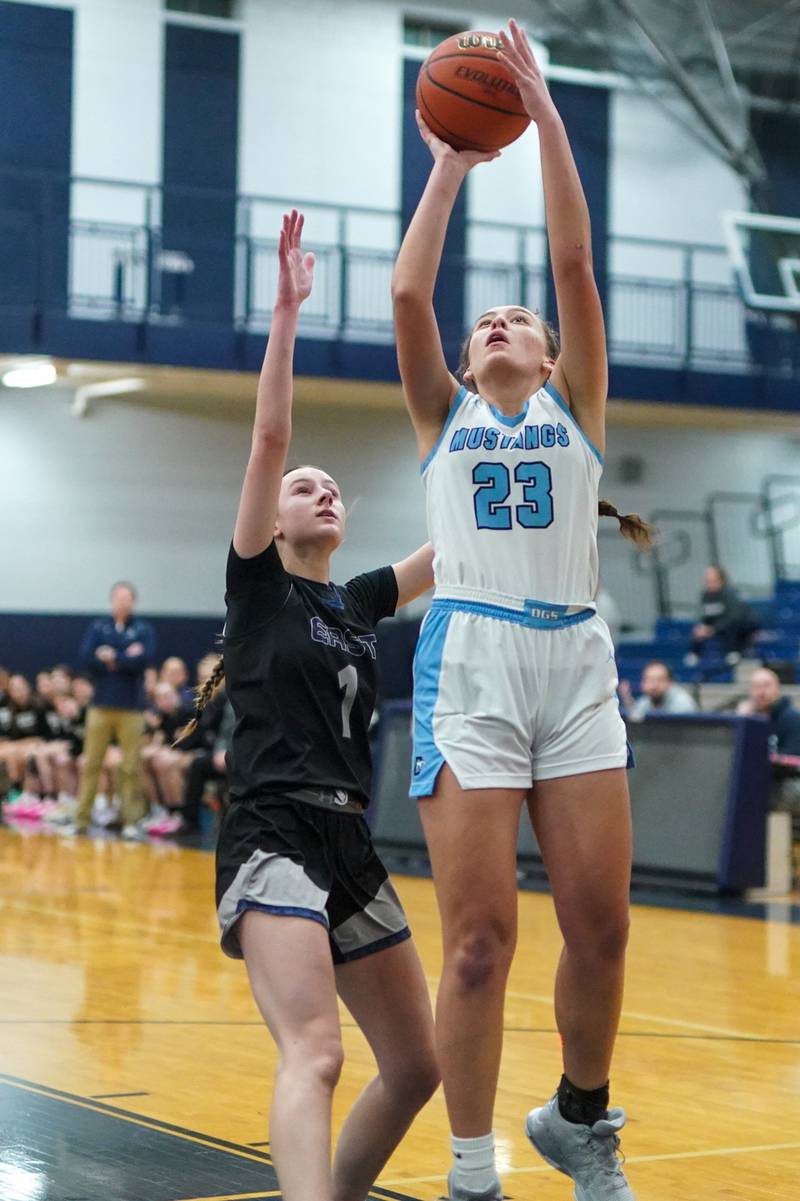 Downers Grove South's Addison Bryant (23) shoots the ball in the pain against Oswego East's Aubrey Lamberti (1) during a 4A Oswego East Regional semifinal girls basketball game at Oswego East High School on Monday, Feb 12, 2024.