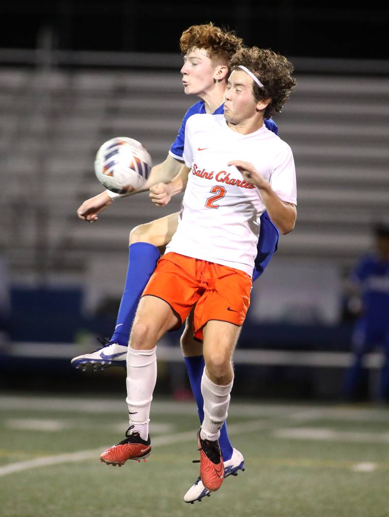 Geneva’s Reece Leonard (left) and St. Charles East’s Brandon Garlan battle for the ball during a game at Geneva on Tuesday, Oct. 3, 2023.