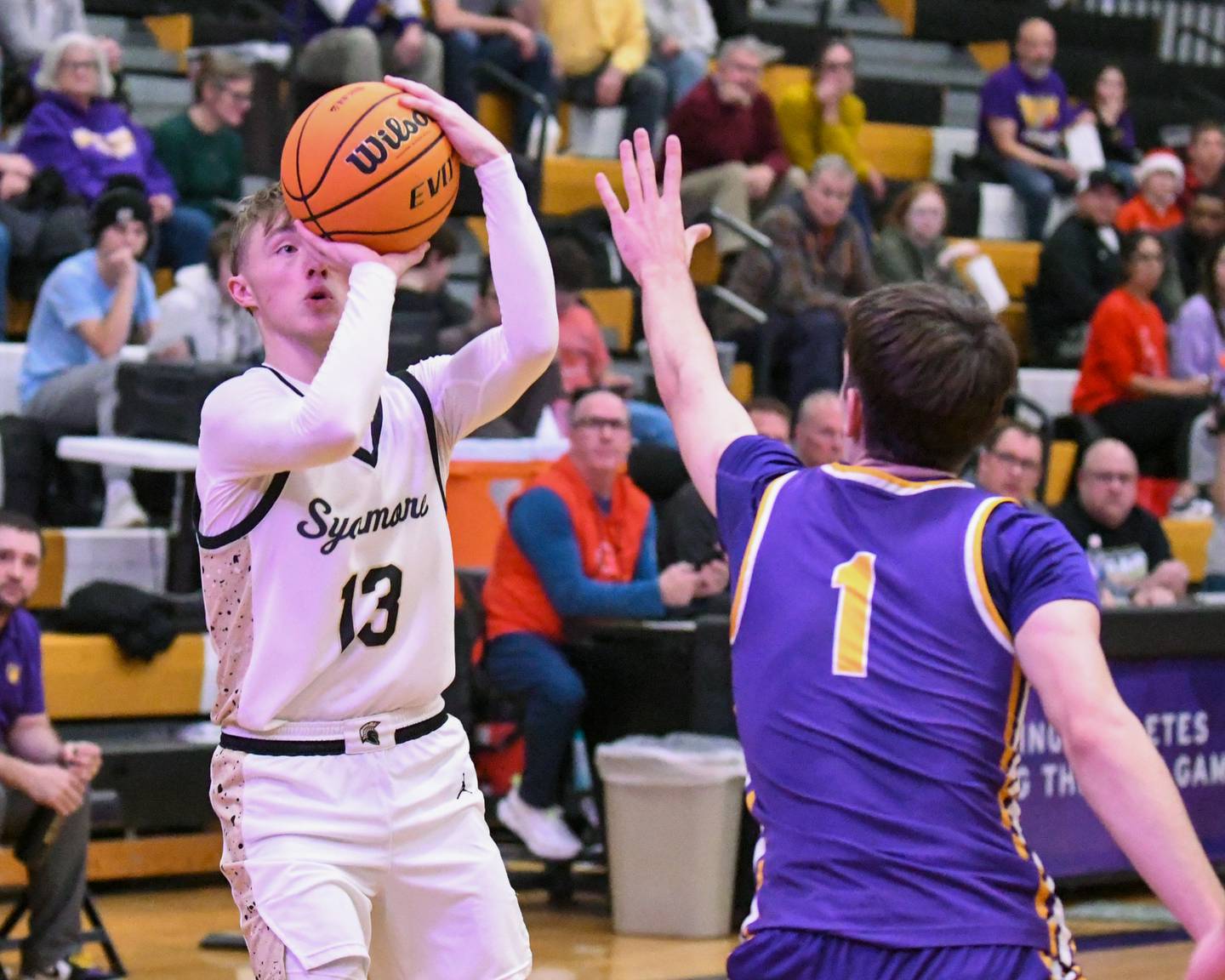 Sycamore's Xander Lewis (13) makes a basket while being defended by Mendota's Cole Tillman (1) during the game on Wednesday Dec. 17, 2025, held at Sycamore High School.