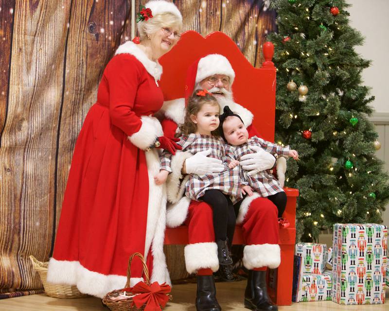 Riley Blonn, 2, and Amelia Blonn, 1, of Aurora visits with Santa and Mrs. Claus during Breakfast with Santa at Batavia Park District on Saturday, Dec. 9, 2023 in Batavia.