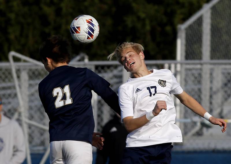Lemont’s Andrew Guzy heads the ball away from Belleville Althoff Catholic's Ben Ysursa during an IHSA Class 3A state semifinal soccer match on Friday, Nov. 8, 2024, at Hoffman Estates High School.