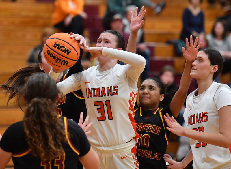 Minooka’s Madelyn Kiper (31) tries to get a shot off as she is swarmed by Montini defenders during a Montini Christmas Tournament game on December 22, 2025 at Montini Catholic High School in Lombard.