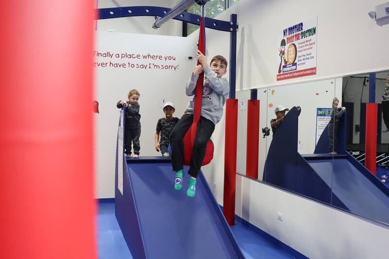Michael plays on the zip line at We Rock the Spectrum Kid’s Gym on Monday, Oct. 14, 2024 in Shorewood.