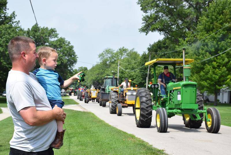 About 70 tractors parade through the streets of Waterman for the 20th