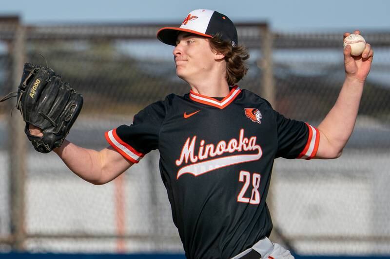 Minooka’s Griffin Hall (28) delivers a pitch against Oswego during a baseball game at Oswego High School on Tuesday, April 18, 2023.