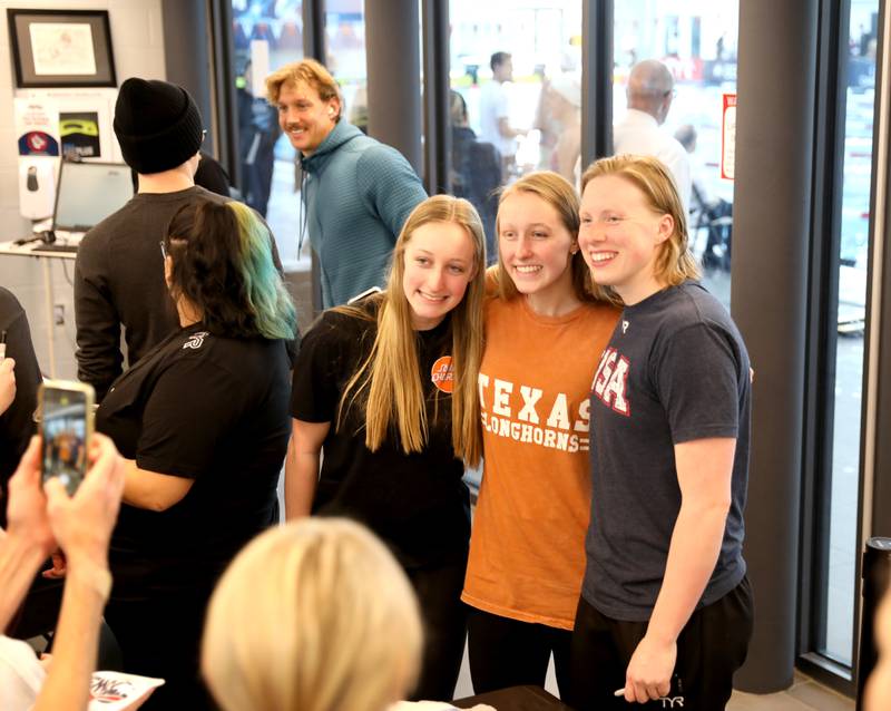 St. Charles Swim Team members Ella (left) and Sophia Mruk (center) pose for a photo with Olympic medalist Lilly King during the Tyr Pro Swim Series Westmont at the FMC Natatorium in Westmont Thursday, March 3, 2022. The meet continues through Saturday.