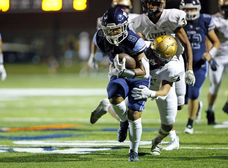 Nazareth Academy's Ethan Enriquez (8) is tackled during the boys varsity football game between Lemont High School and Nazareth Academy on Friday, Sept. 2, 2022 in LaGrange, IL.