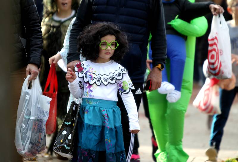 Finley Rosso, as Mirabel from the movie Encanto, goes trick-or-treating at Geneva businesses on Thursday, Oct. 27, 2022.