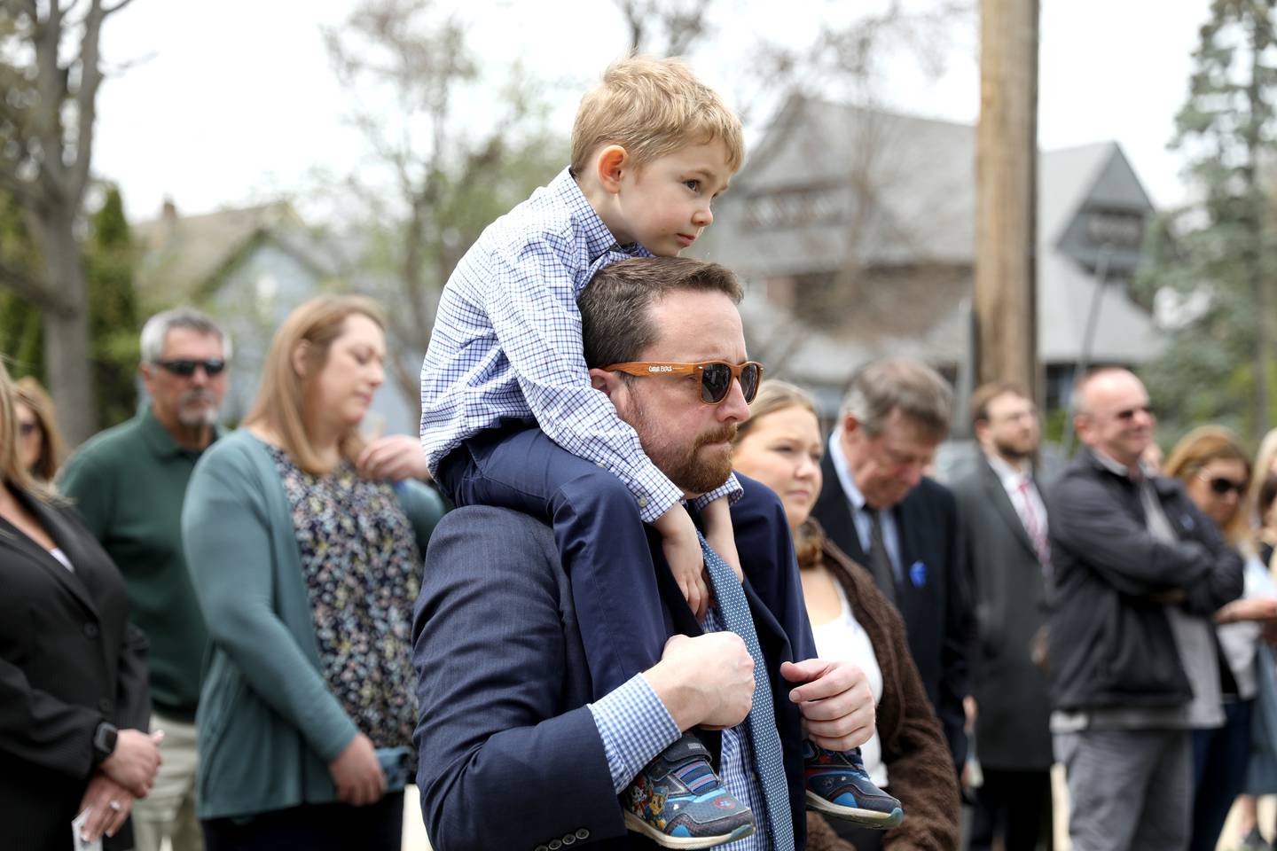 Joe Gay and his son, Liam, 5, watch as a garden is dedicated in honor of their wife and mom, Debra Bree, at the Kane County Child Advocacy Center in Geneva on Friday, April 29, 2022. Bree, who was the executive director of the Kane County Child Advocacy Center, died Aug. 27, 2020 of colon cancer.