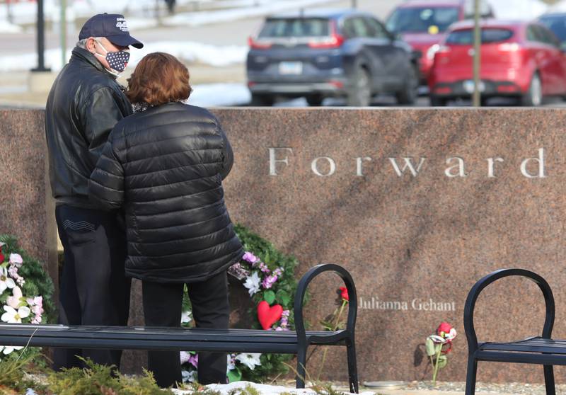 Larry Gehant and Charlotte Schiller stand in front of the stone that bears their niece, Julianna Gehant's, name Monday, Feb. 14, 2022, during a remembrance ceremony at the Forward, Together Forward marble memorial outside Cole Hall at Northern Illinois University in DeKalb. Monday marked the 14th year since the deadly shooting took place on campus which took the lives of five people.