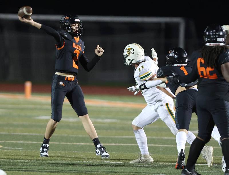 DeKalb's Cole Latimer throws a pass just ahead of the pressure of Waubonsie Valley's Bryce Provis during their game Friday, Sept. 29, 2023, at DeKalb High School.