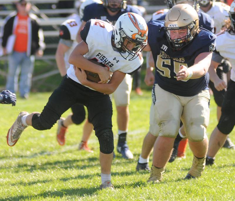 Marquette's Noah Barth tackles Fisher's Blake Booth at Gould Stadium on Saturday, Oct. 23, 2021.