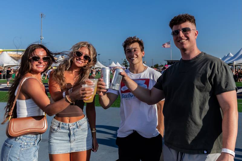 Caitlyn Hoover (Plainfield), Jadah Brandenburg (Shorewood), Blake Brandenburg (Shorewood), and Tristan Vidican (Shorewood) share a toast during Taste of Joliet on June 21, 2025.
