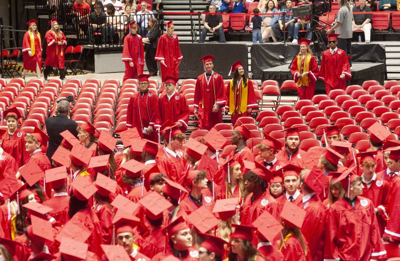 Graduates proceed into the stadium to the playing of "Pomp and Circumstance" during Yorkville High School's class of 2022 graduation ceremony at the NIU Convocation Center on Friday, May 20, 2022.