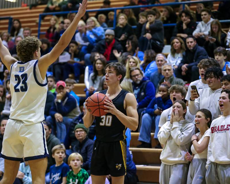 Hinsdale South's Brendan Savage (30) looks to pass inbounds in front of the Downers Grove South student section during basketball game between Hinsdale South at Downers Grove South. Dec 1, 2023.