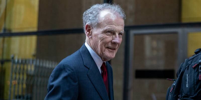 Former Illinois House Speaker Michael Madigan smiles as he exits the Dirksen Federal Courthouse in Chicago on Monday after opening statements in his federal corruption trial concluded.