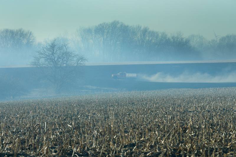 A brush truck sprays water on a charred farm field near the 26000 block of 2500 East Street on Wednesday, Feb. 18, 2026 near Ohio. A Mutual Aid Box Alarm call was elevated to the second-alarm for the brush fire. Bureau County Fire departments from Princeton, Ohio, Malden and others assisted with the fire.