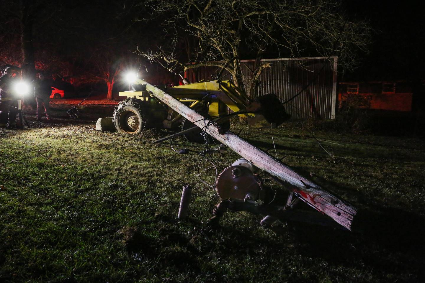 Firefighters were able to free a man without injury who was trapped in a tractor after a utility pole collapsed onto him Monday evening near Marengo, officials report.