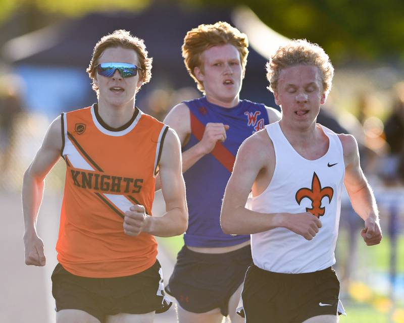 Kaneland Evan Nosek, left, Jedidiah Wilson of St. Charles East, right, and Sean Heetland of West Aurora run together during the 3200 meter run at the Kane County track and field meet held at Marmion Academy in Aurora on Friday May 3, 2024.