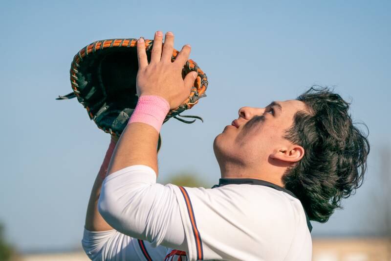 Oswego’s Benjamin Hernandez (10) plays an infield pop-up during a baseball game against Minooka at Oswego High School on Tuesday, April 18, 2023.