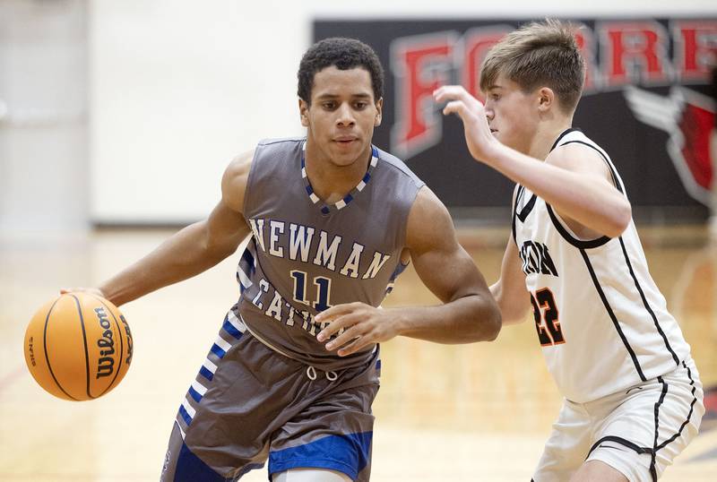 Newman’s Tyson Williams handles the ball against Byron’s Landon Smith Friday, Dec. 19, 2025, in the Forreston Holiday Tournament title game.