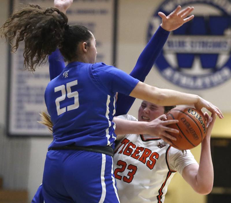 Crystal Lake Central's Leah Spychala tries to shoot the ball as she is defended by Burlington Central's Mia Hansen during the IHSA Class 3A Woodstock Regional Championship girls basketball game on Thursday, Feb. 15, 2024, at Woodstock High School.