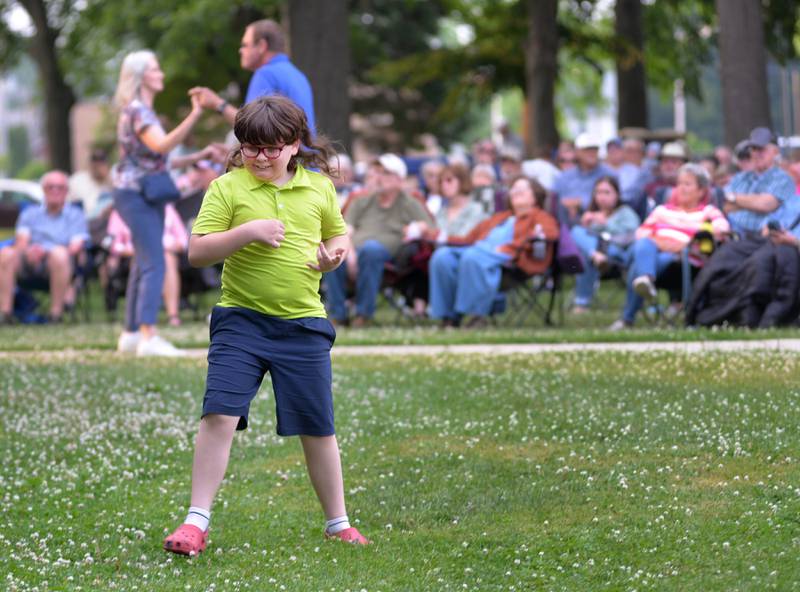 Jonathan Zell, 9, of Polo, plays the air guitar along with RIck Lindy during a tribute to Roy Orbison at the Mt. Morris Jamboree on Friday, June 13, 2025. A large crowd turned out for the opening night of the free music series, held on the Campus in downtown Mt. Morris. The free concerts are offered each Friday throughout the summer.
