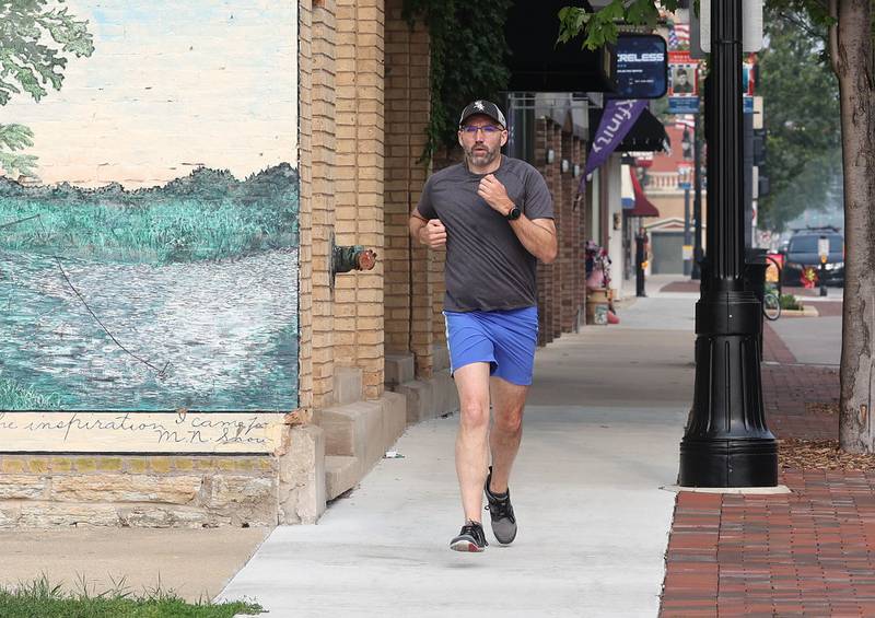 Shawn Beck, from DeKalb, runs west Wednesday, June 28, 2023, on Lincoln Highway between First and Second Streets in DeKalb. Beck recently completed his goal of running every street in DeKalb County.