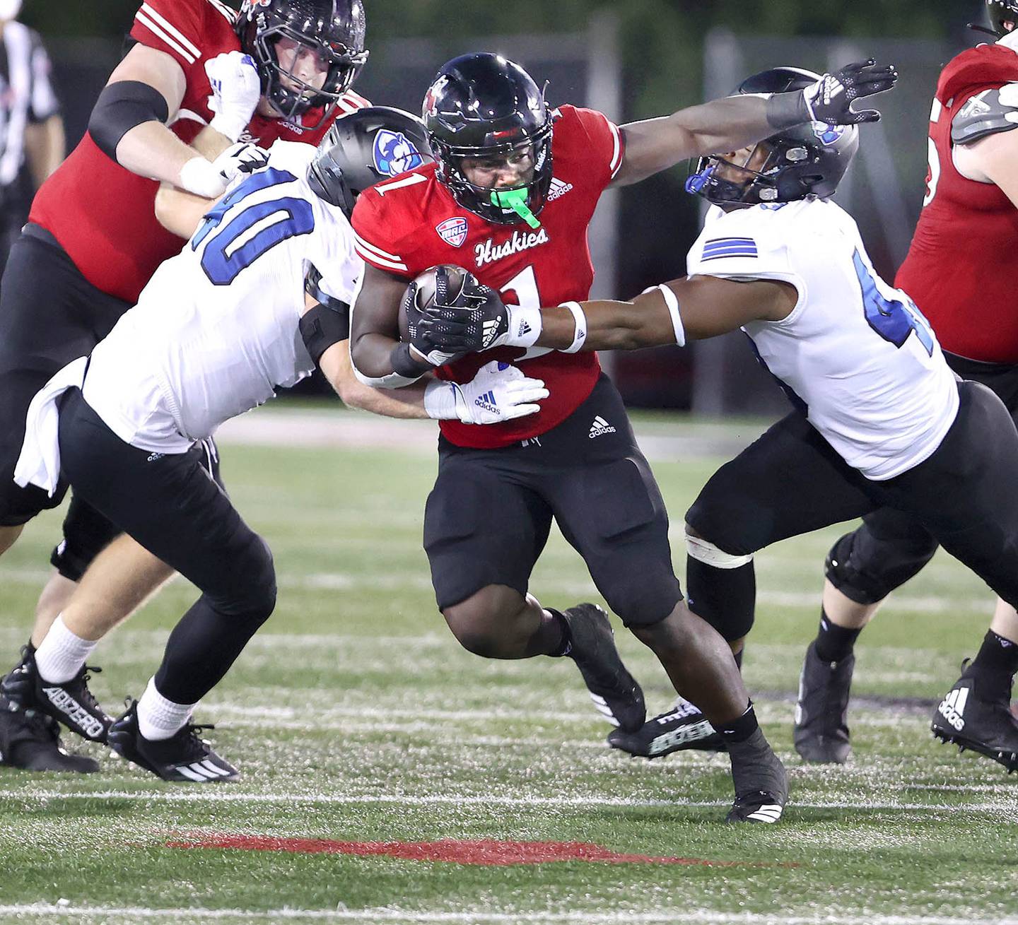 Northern Illinois Huskies running back Antario Brown splits two Eastern Illinois defenders during their game Thursday, Sept. 1, 2022, in Huskie Stadium at NIU.