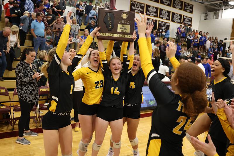 Joliet West holds up the championship plaque after a two set win over Sandburg in the in the Class 4A Lockport Sectional title match on Wednesday.