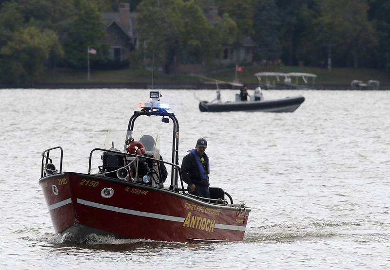 Divers from the Antioch Fire Protection District and a sonar team from the Illinois Department of Natural Resources continue searching Tuesday, Oct. 7, 2025, on Fox Lake near Antioch for a man thrown from a boat he was test driving Monday night.
