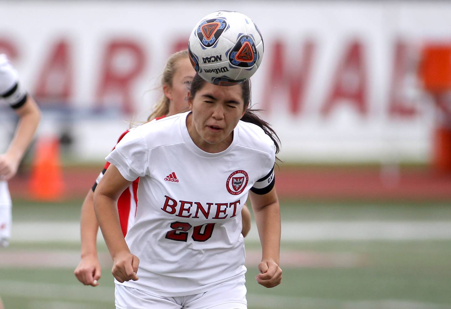 Benet’s Annastacia Thiel (20) heads the ball during the IHSA Class 2A state championship game against Triad at North Central College in Naperville on Saturday, June 4, 2022.