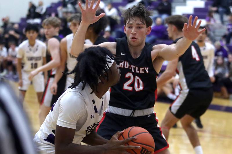 Huntley’s Ethan Blackmore, right, guards Hampshire’s Aman Adeshina in boys basketball at Hampshire on Friday.