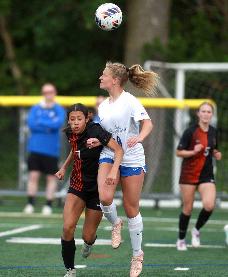 St. Charles East's Mya Leon and St. Charles North's Chloe Kirsten head the ball during a Class 3A Glenbard West Sectional semifinal game on Tuesday, May 27, 2025 in Glen Ellyn.
