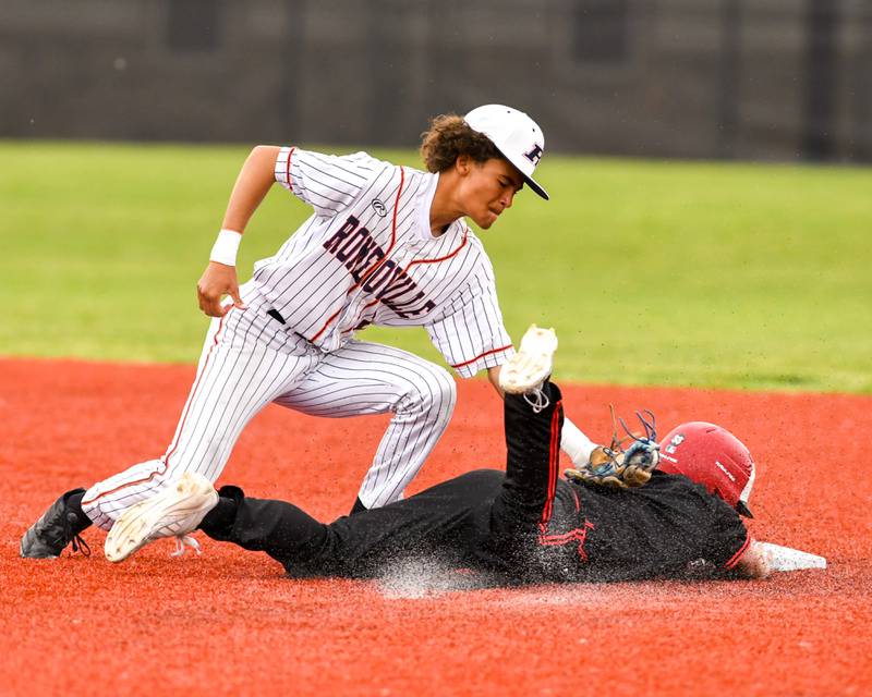 Romeoville's Justin Perez (2) catches the ball and tags out Yorkville's Gabe Sanders (1) during the regional game on Thursday May 29, 2025, held at Yorkville High School.
